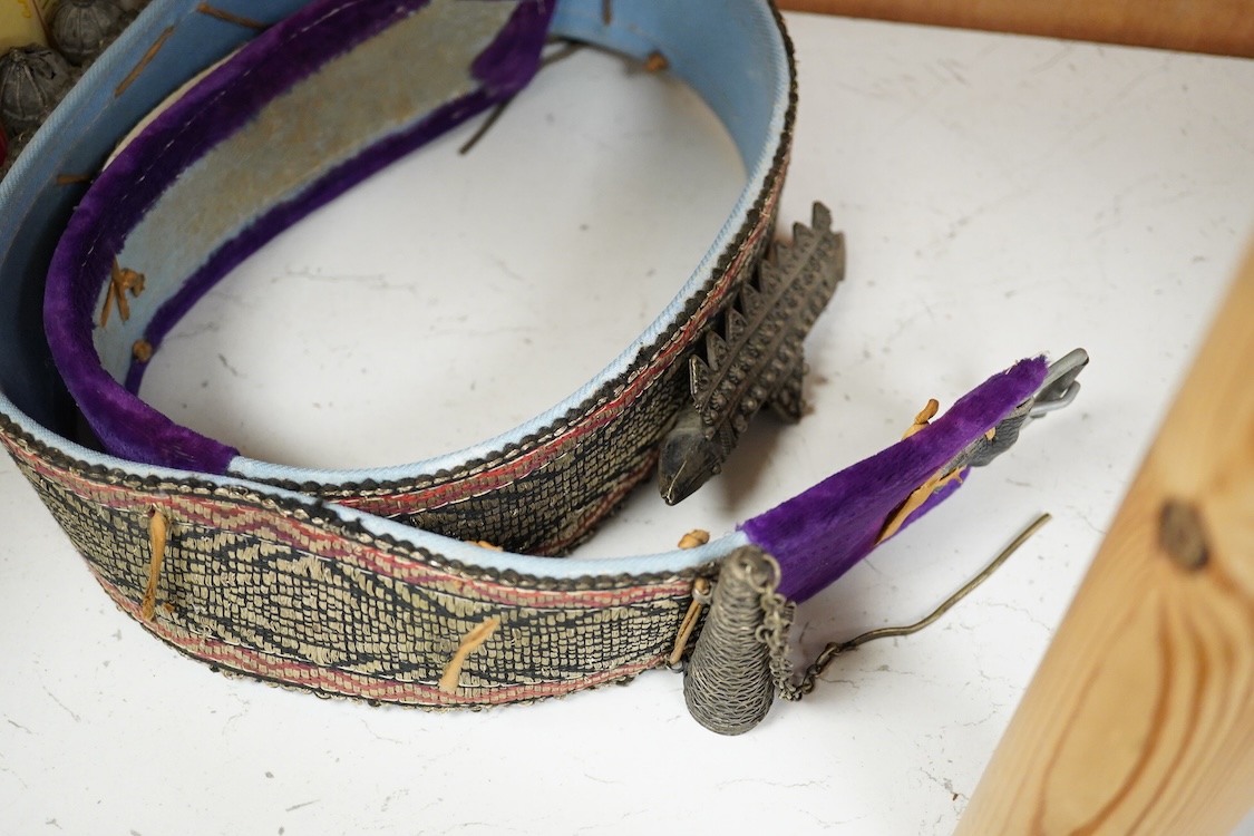 Two Yemeni white metal daggers white and two belts, largest dagger 31cm long